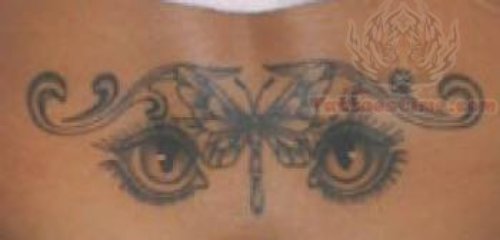 Eyes And Dragonfly Tattoo On Lower Back